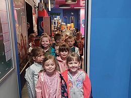 Dzieci stoją w przejściu do sali kinowej